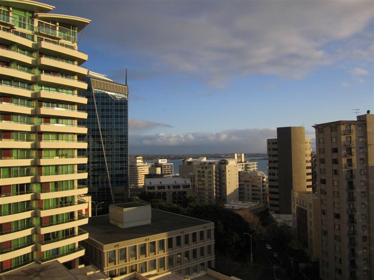 View of Auckland harbour from hotel balcony. The sea is over there between the buildings and the sky