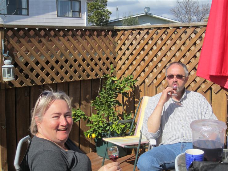 Yvonne and Steve on their decking, trying homemade cherry brandy