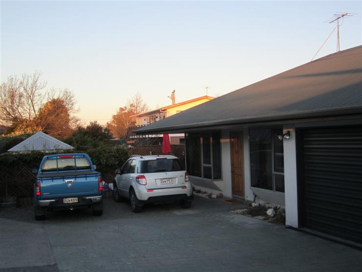 Steve and Yvonne's vehicles and the front of the bungalow