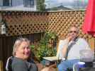 Yvonne and Steve on their decking, trying homemade cherry brandy